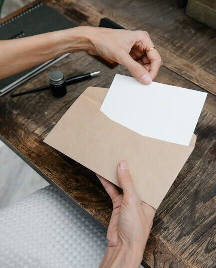 Close-up of woman handling a blank card and envelope at a rustic desk.